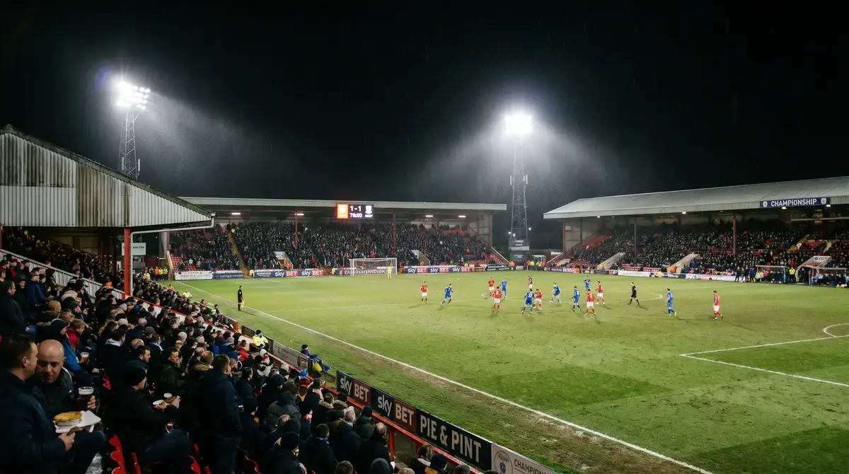 Championship football ground under floodlights during midweek league fixture