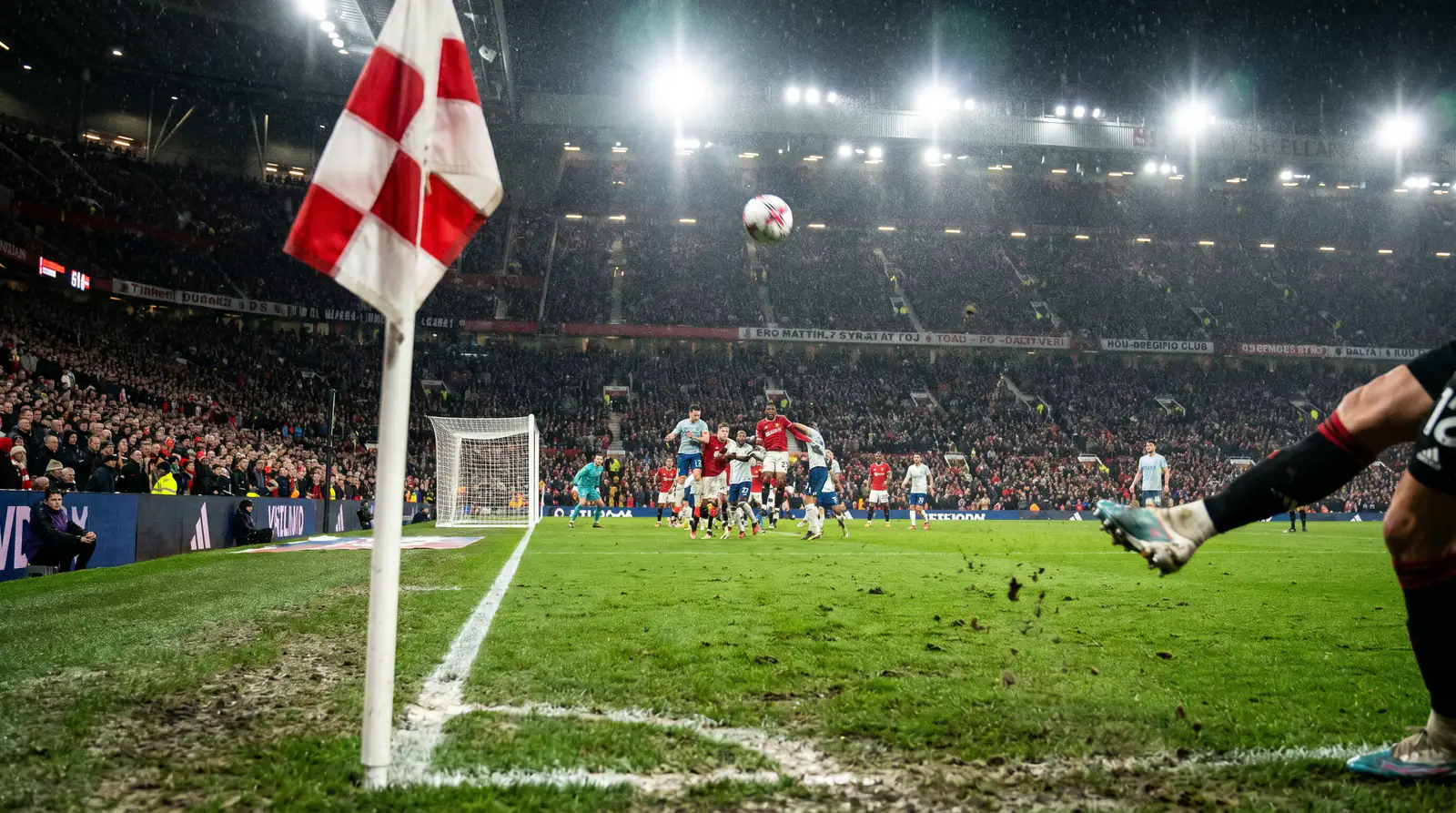 Football corner kick being taken during an English league match with players crowding the penalty area