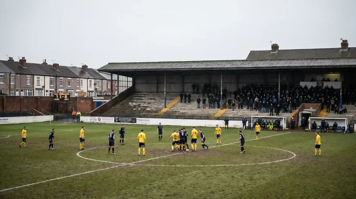 EFL Championship match at a lower league ground with fans in the stands
