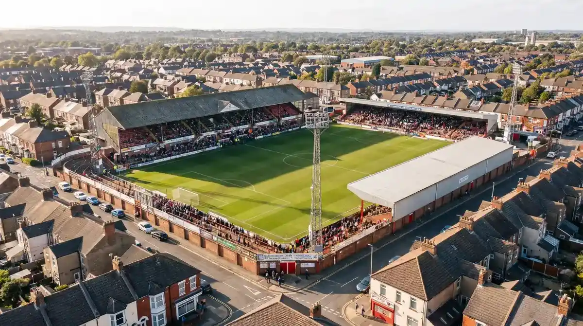 Compact League Two stadium with close spectator proximity to football pitch