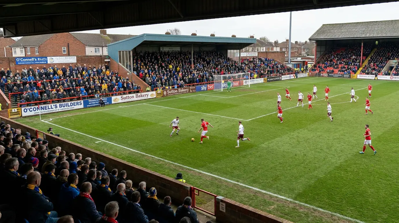 Compact League Two stadium with fans close to the pitch