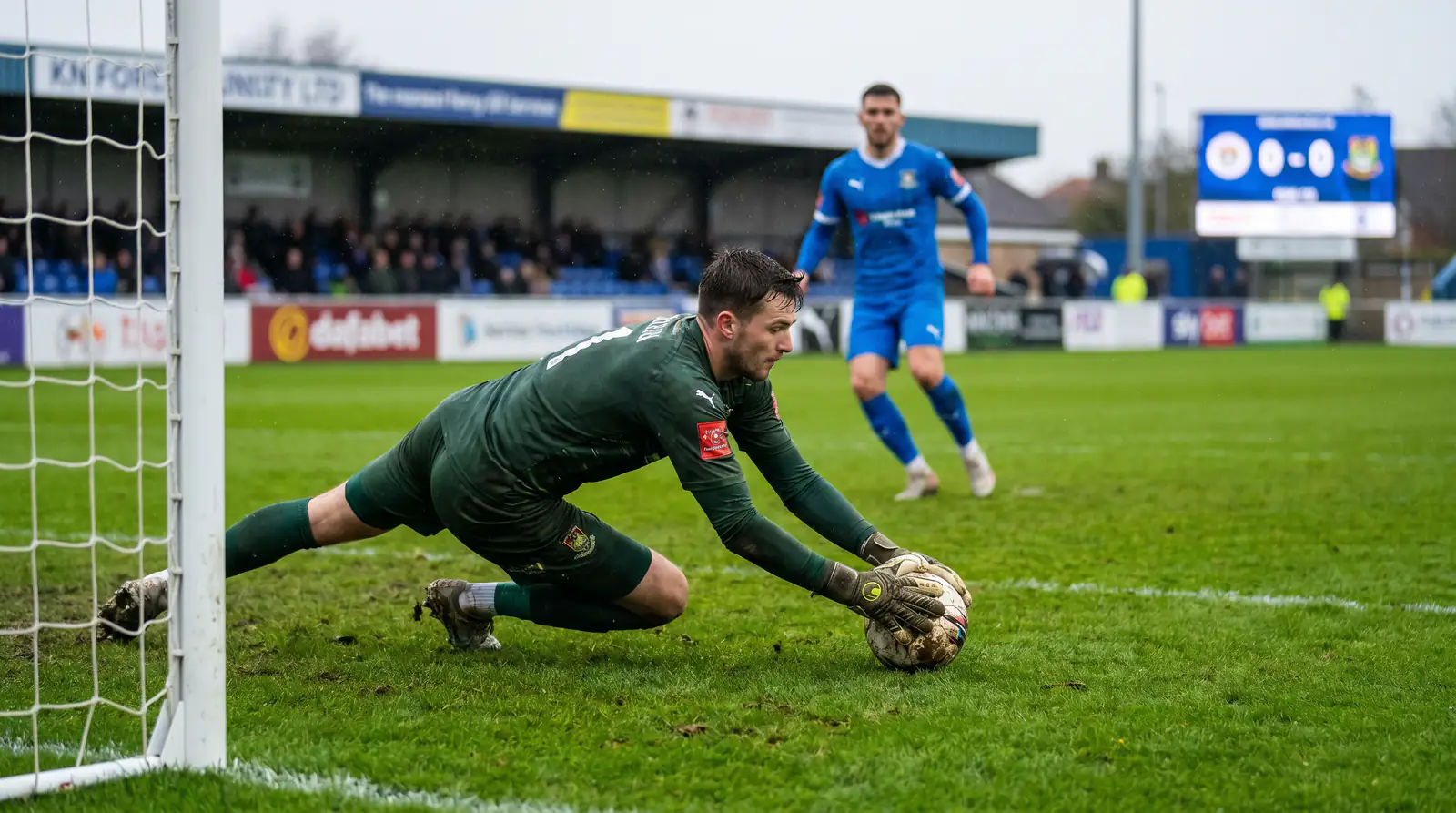 Goalkeeper collecting the ball during a low-scoring League Two match
