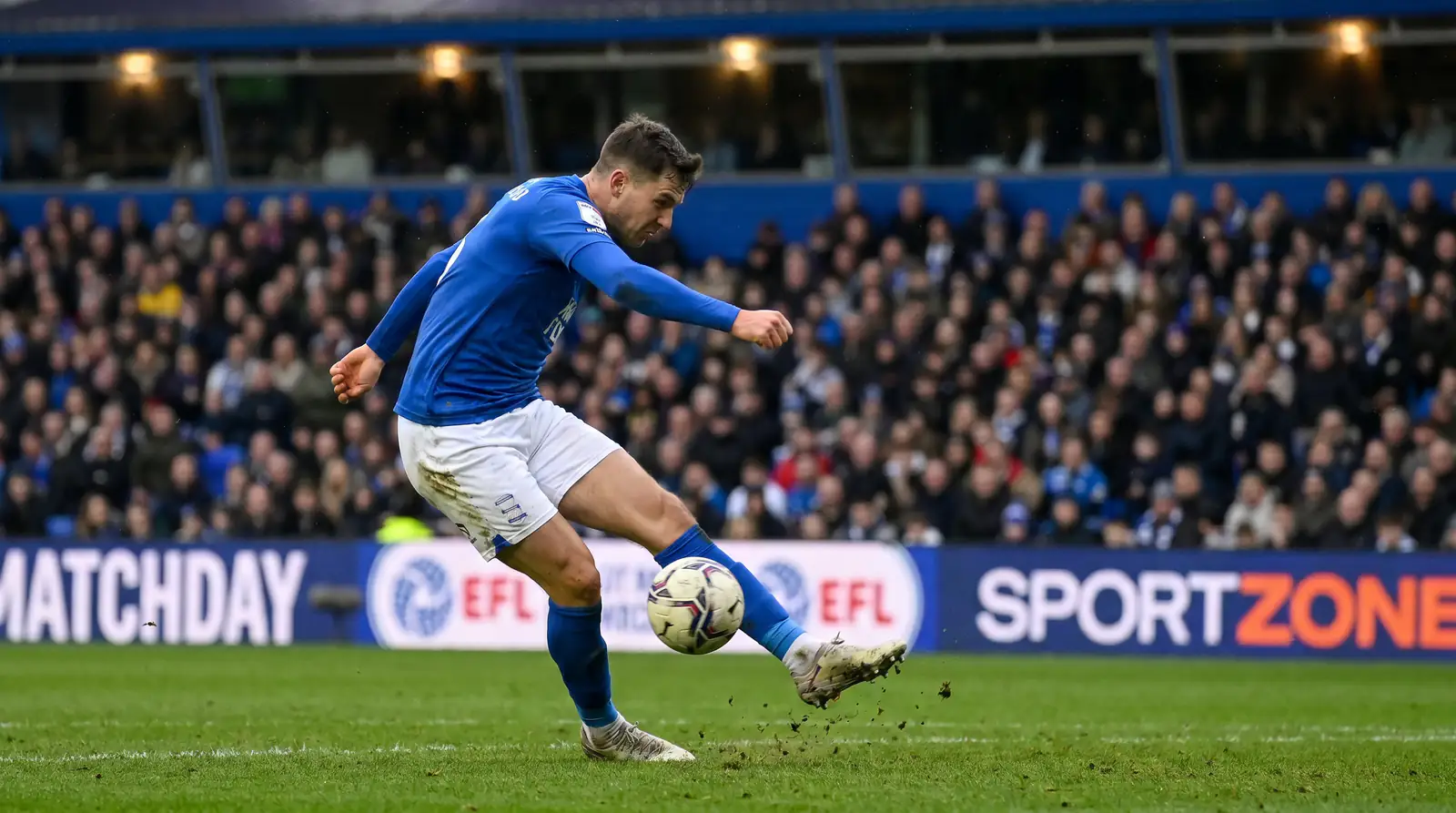 Football player taking a shot on goal representing player props betting markets for shots and tackles