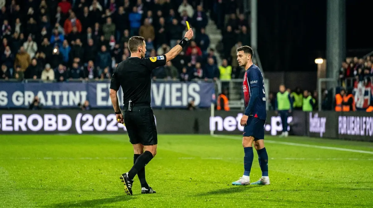 Referee showing yellow card during English league football match