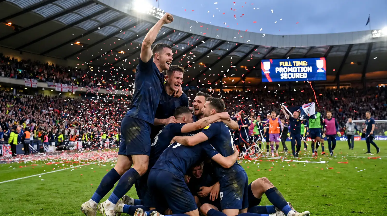EFL promotion celebration with players on the pitch after securing a place in a higher division